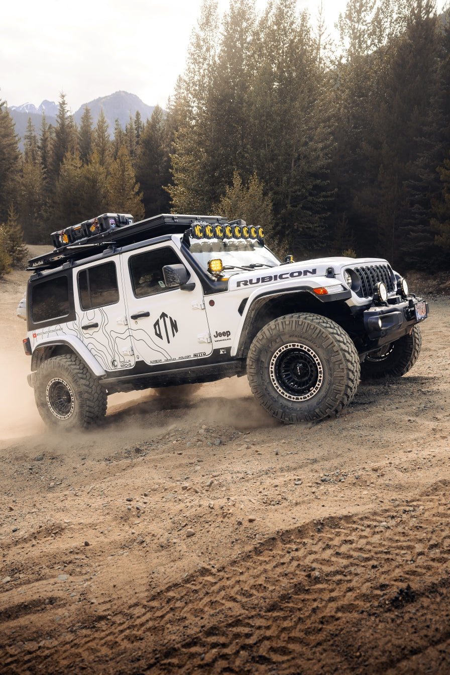 Truck  jeep on a dusty road with a custom topographic vinyl decal kit installed